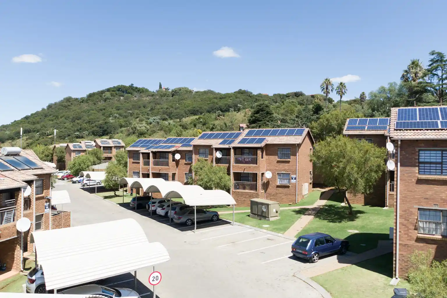 Southgate Ridge apartments with solar panels and green hills