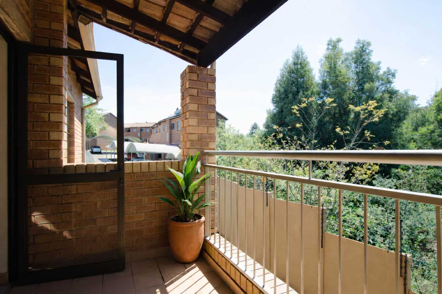 Private covered balcony overlooking trees