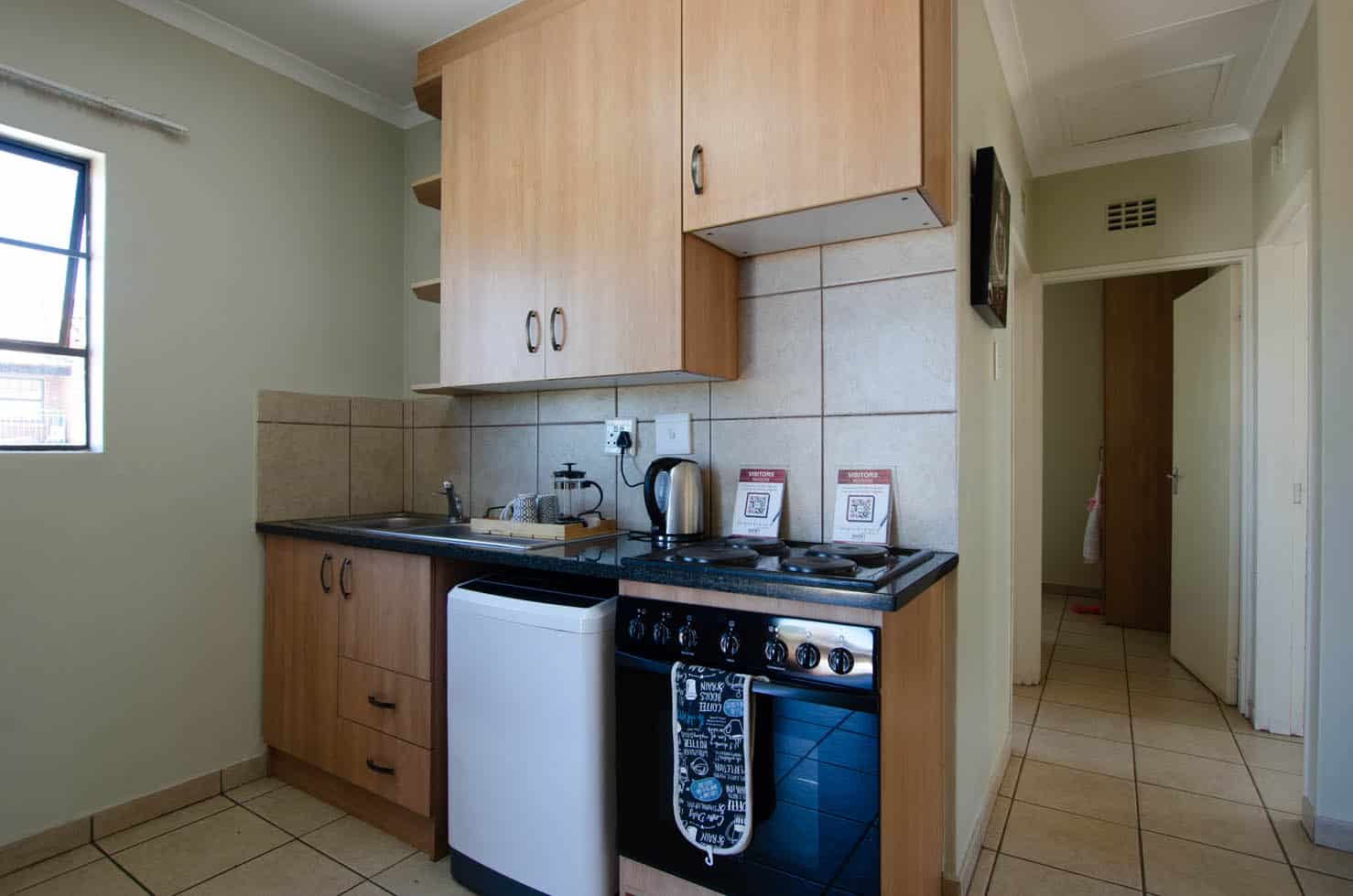 Fitted kitchen with oven, hob and storage